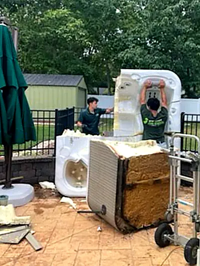 The crew cutting the hot tub shell into sections
