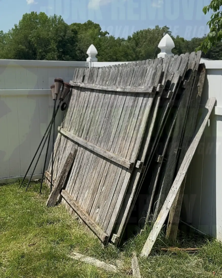 Before: old wooden fence panels leaning in a backyard corner