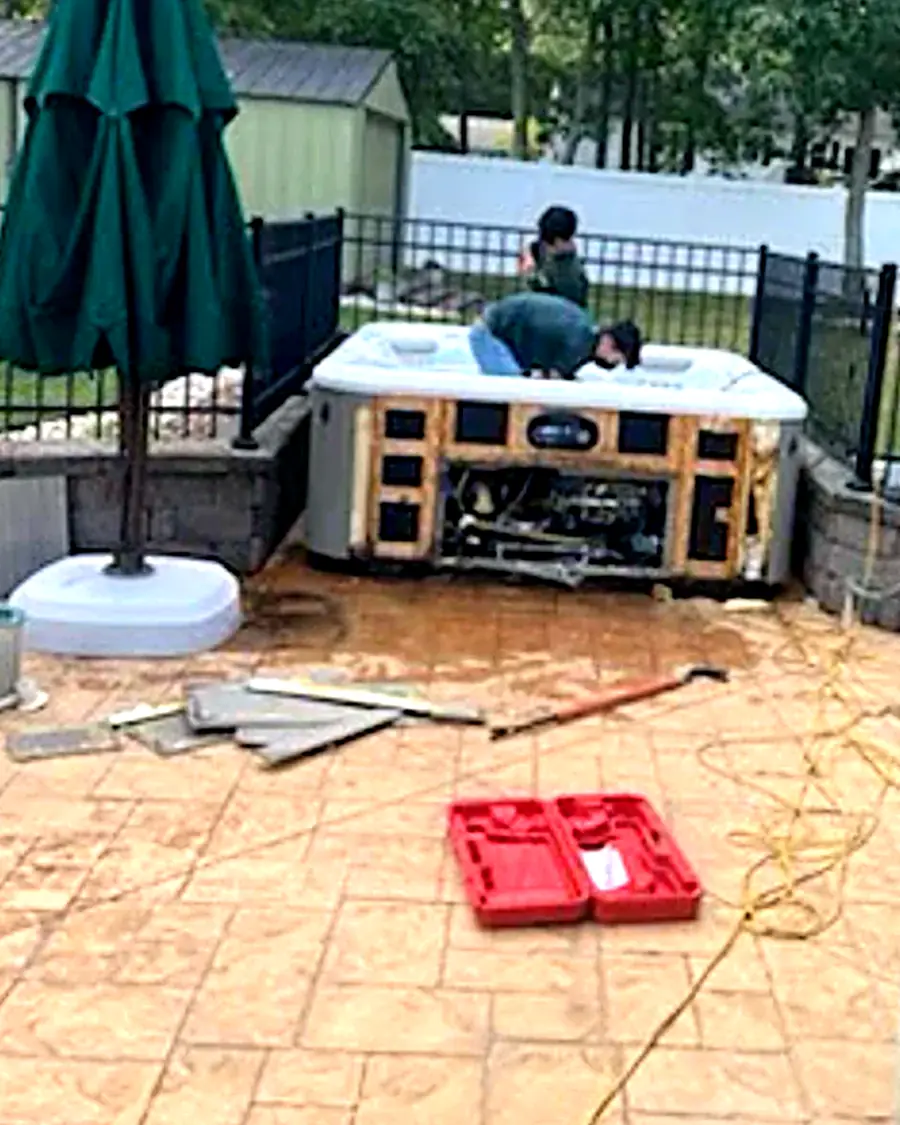 Before: an old hot tub on a backyard patio with its side panels removed