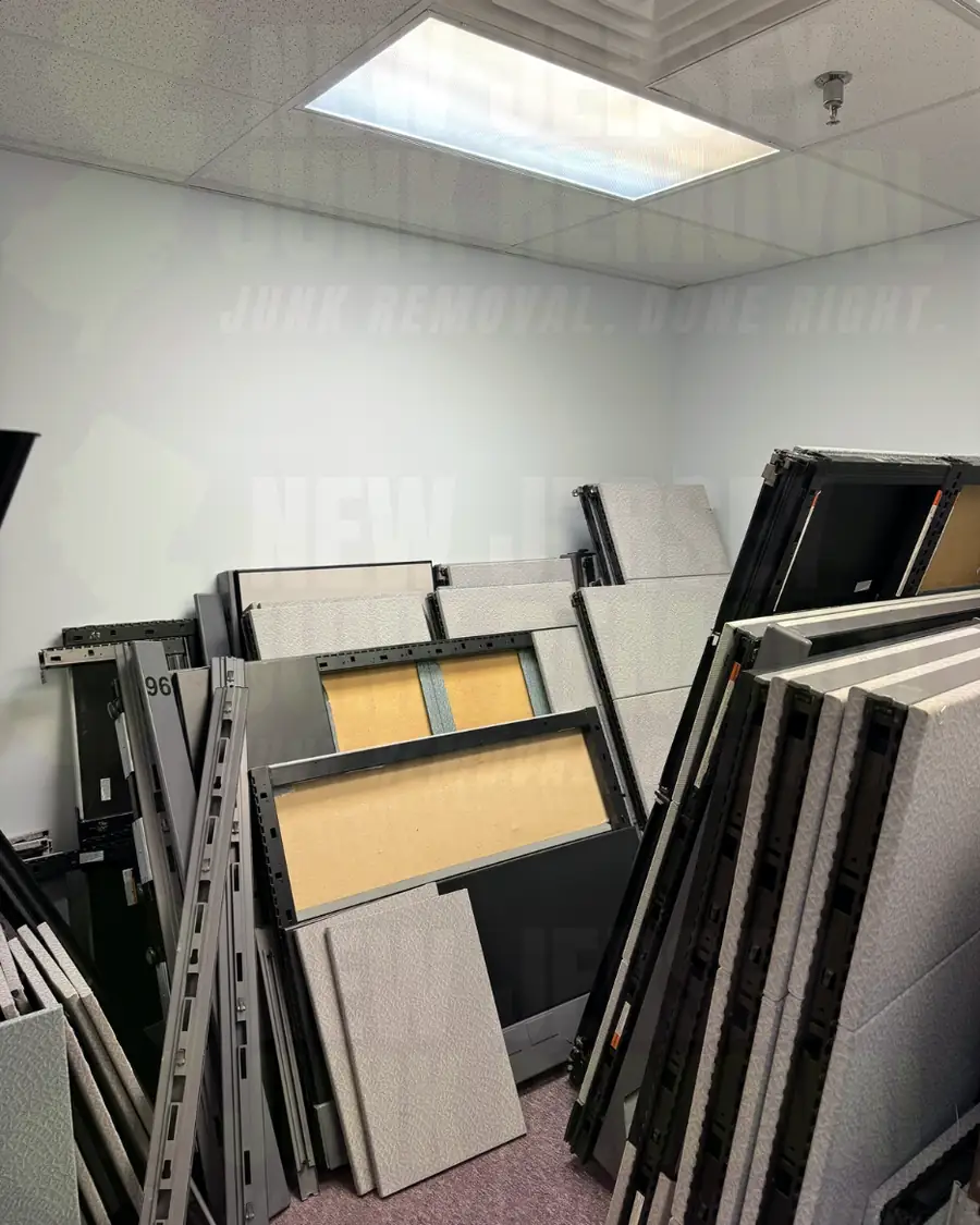 Before: an office room stacked with old cubicle panels