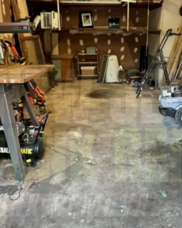 After: the same garage with the mower and clutter gone and the floor clear