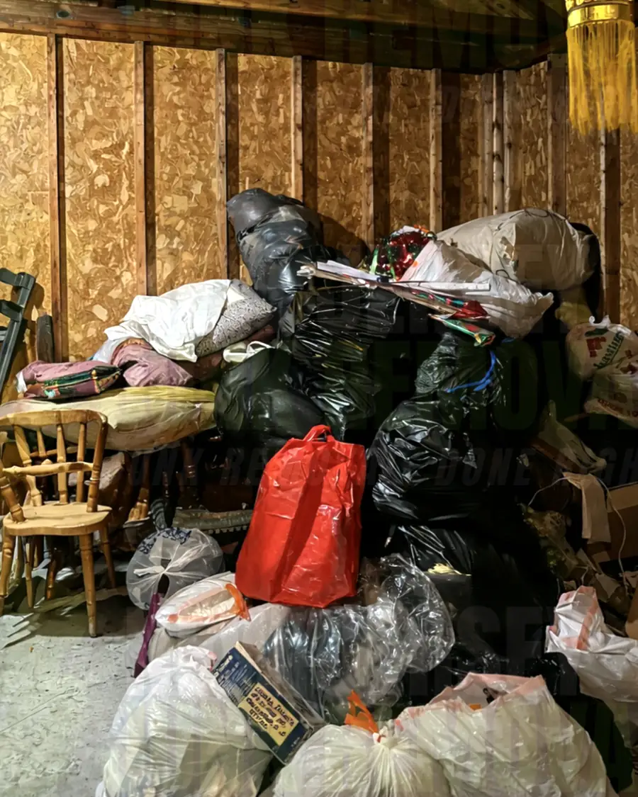 Before: a room filled with trash bags, furniture and belongings