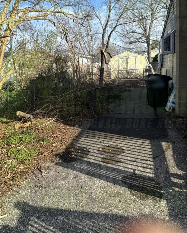 After: the same paved walkway beside the house cleared