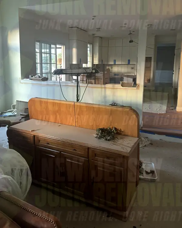 After: the same room with the cabinets gone and a low wood sideboard left in place