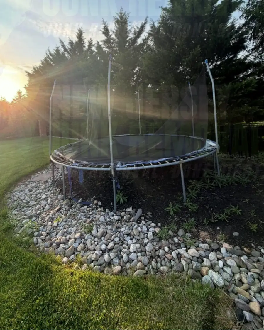 Before: an old trampoline in a stone-edged backyard bed