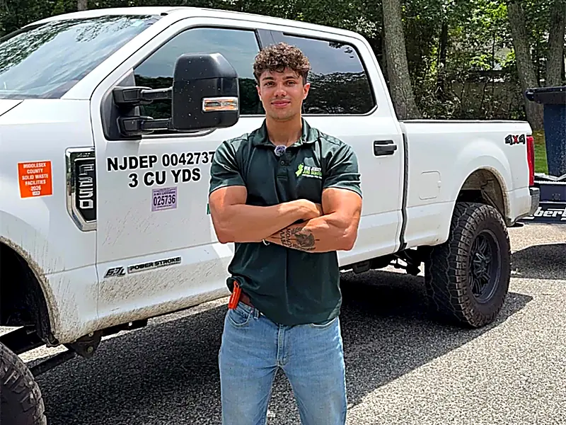 Dominic, owner of New Jersey Junk Removal, standing in front of his work truck
