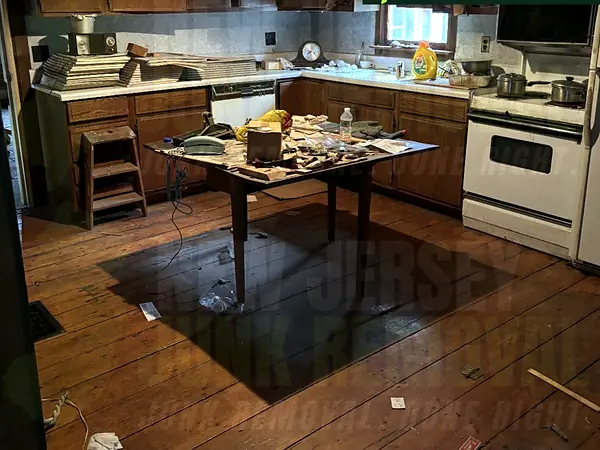 A dated kitchen with appliances and clutter before a cleanout