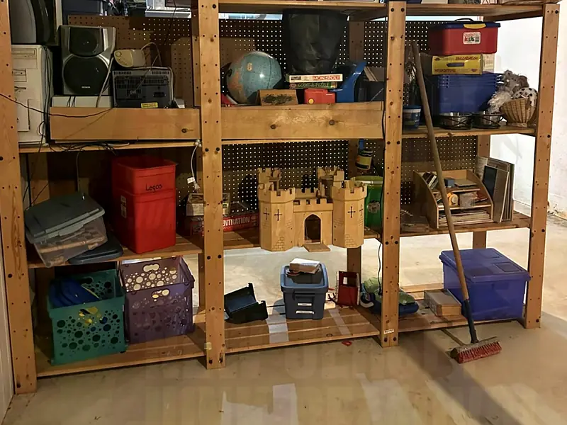 Basement shelving packed with stored bins and boxes