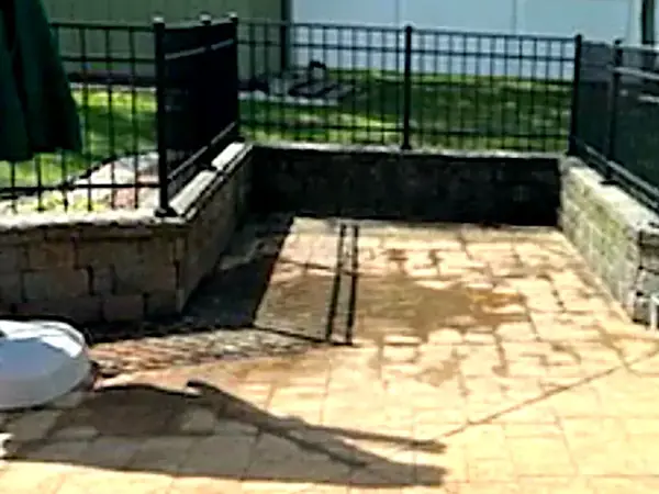 A backyard patio cleared and swept after an old hot tub was cut apart and hauled away