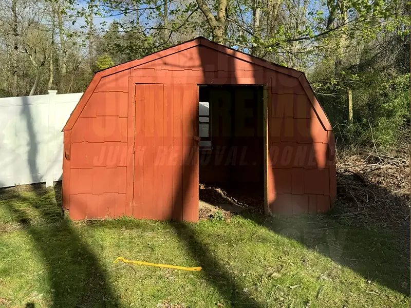 An old red wooden shed before removal